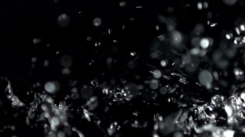 Abstract Water Droplets Against Black Background in Slow Motion