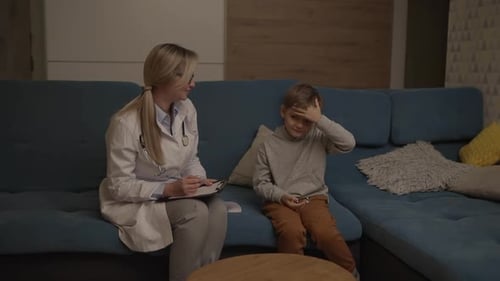 Doctor Consults With Young Boy at Home