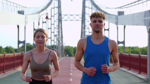Close Up of Caucasian Joyful Young Man and Woman Running Working Out Outdoors