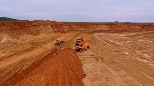 Crawler Excavator Standing in Sand Quarry. View From Above of Machinery Working