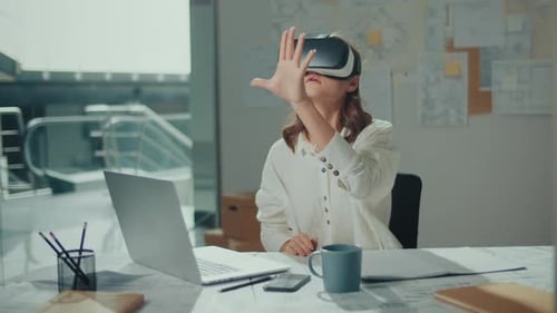 Woman Wearing VR Glasses Sits in a Bright Office Innovative Technologies