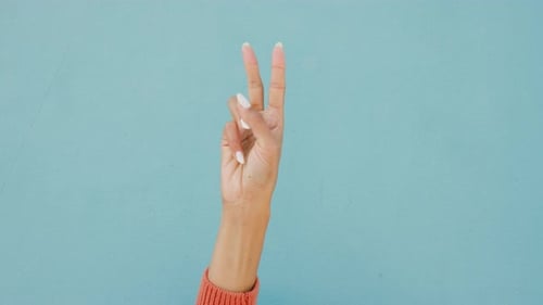 Countdown fingers or hand gesture on a mockup blue wall background