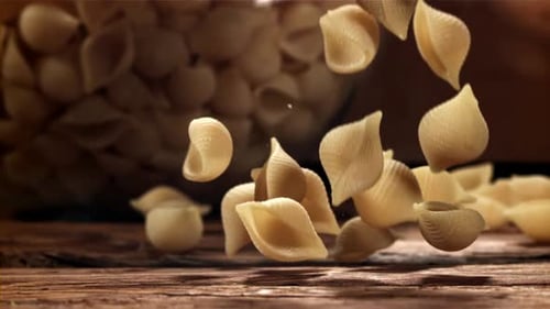 Dry Pasta Falls on a Wooden Table Filmed on a Highspeed Camera at 1000 Fps
