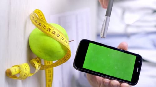 Vertical video of nutritionist points to smartphone with green screen, Healthy eating