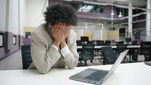 Man Working at Computer in Open Office Space