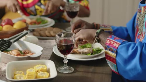 Adults Eating Dinner Together at Wooden Table