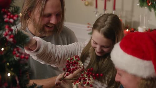 Family Decorating Christmas Tree With Ornaments