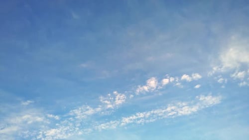 White Clouds Float Slowly in a Blue Sky