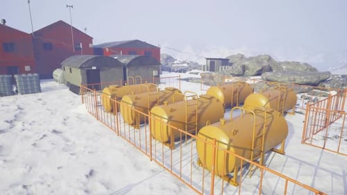 Red Buildings and Rocks Surround Symmetrical Fuel Storage Area