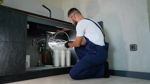 Plumber Installing Reverse Osmosis Water Filtration System