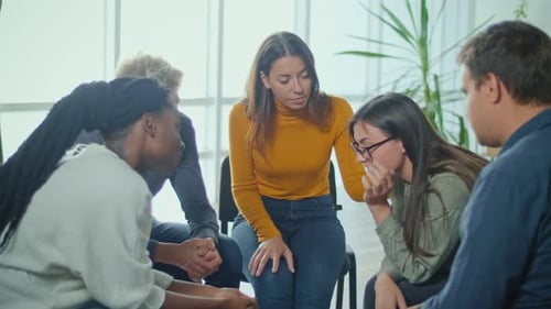 Support Group Comforting Sad Woman in Circle
