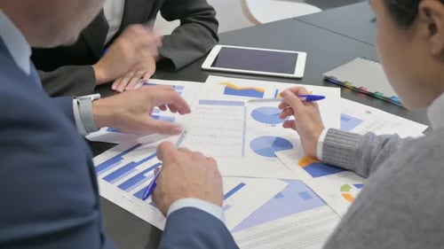 Close Up of Hands Working on Business Reports