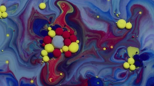 Vibrant abstract texture of red blue and yellow oil paint swirling together
