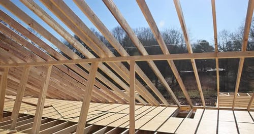 Wooden Building Frame Under Construction on Sunny Day