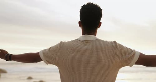 Beach, sunset and man with smile for freedom in vacation, weekend holiday and journey in California
