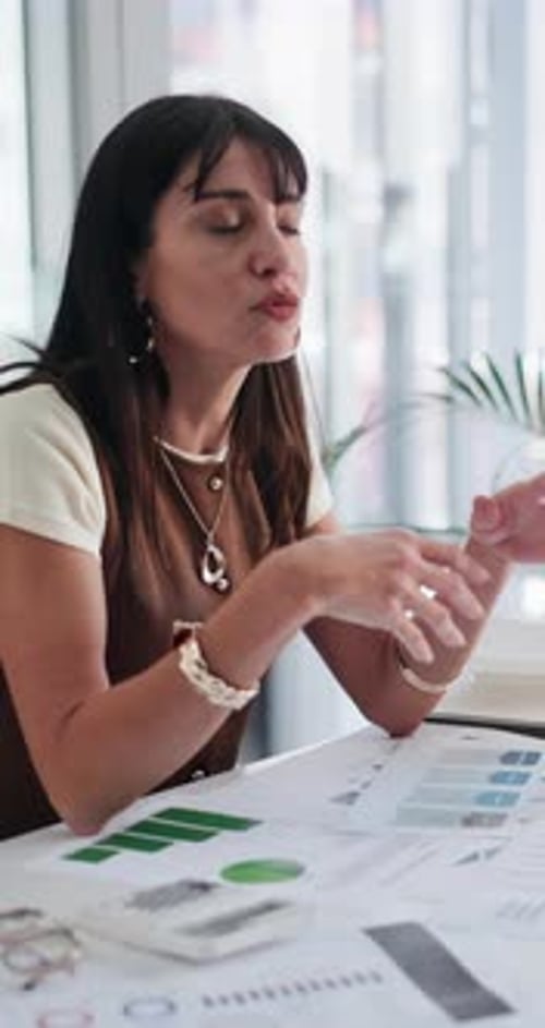 Paperwork, business woman and discussion in meeting for annual report, data analysis and planning