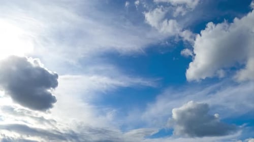 White soft clouds moving quickly by the horizon. Cloudscape formation low angle view.