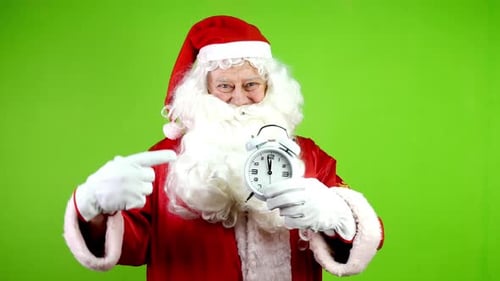 Santa Claus Points to Alarm Clock on Green Screen