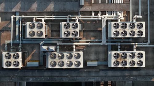 Aerial View of Multiple Cooling Units Situated on a Rooftop The System Features a Series of Large