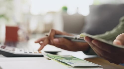 Budget, money and woman hands calculating her savings, house bills and home calculator for financial