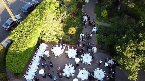 Aerial view of wedding reception ceremony with a round table setup and people enjoying themselves in