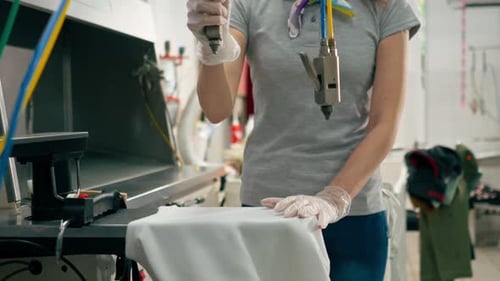 Woman Works on Garment with Specialized Tool