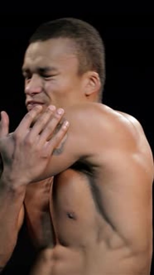 Man Massages His Aching Shoulder