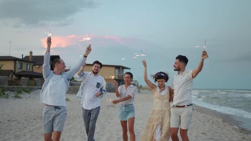 Friends Celebrate on Beach with Sparklers