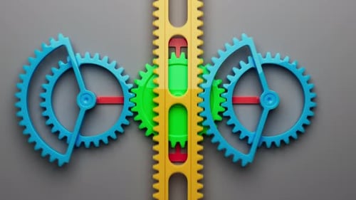 Looped animation of a group of multi-colored children plastic gears.