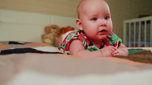 Portrait of a Cute Little Baby Girl in a Colorful Shirt