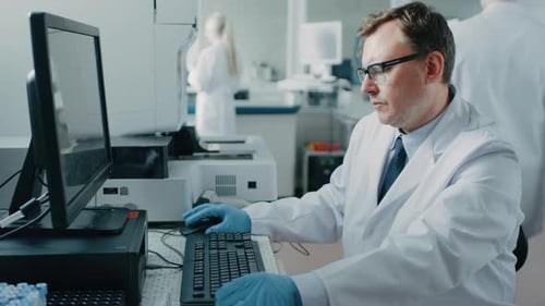 Scientist using computer in modern laboratory