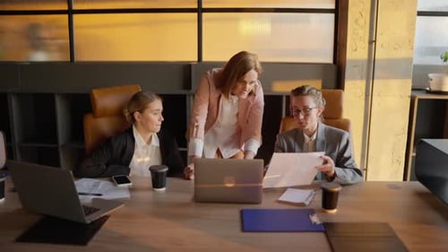 Women Collaborate on Project in Bright Conference Room