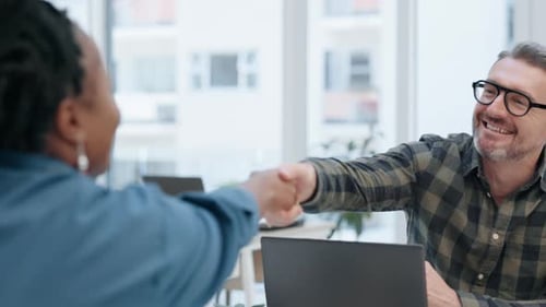 Business Colleagues Shaking Hands in Office Space