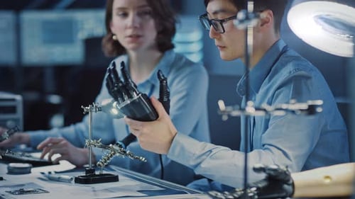 Technological Prosthetic Robot Arm is Tested by Two Professional Development Engineers in a High Te