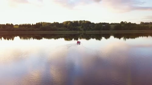 Family on a Pedal Boat on a Lake at Sunset.