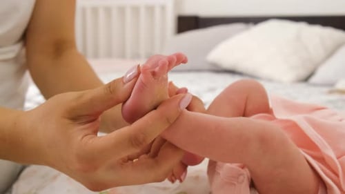 Adult Massaging Baby's Foot