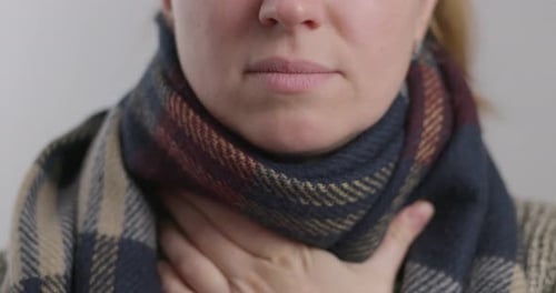 Woman Sprays Medication into Sore Throat Close Up