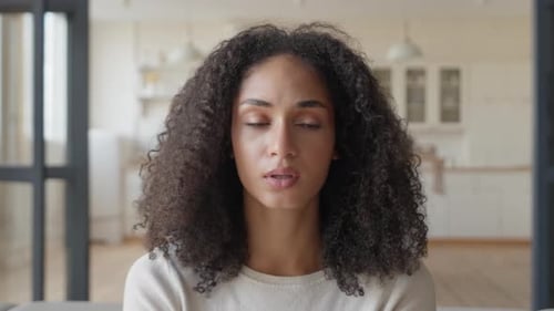 Woman Massaging Temple Suffering from Headache at Home