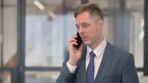 Portrait of Young Businessman Talking on phone