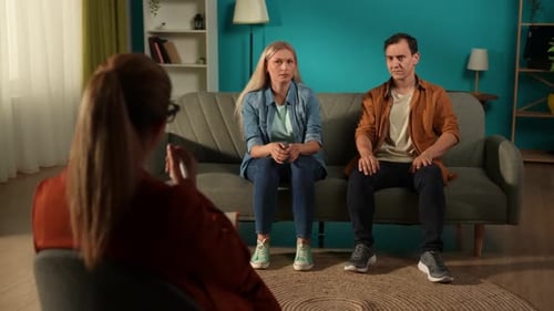 A Couple at a Psychotherapy Session Solving Their Problems Back View of a Female Psychologist Giving