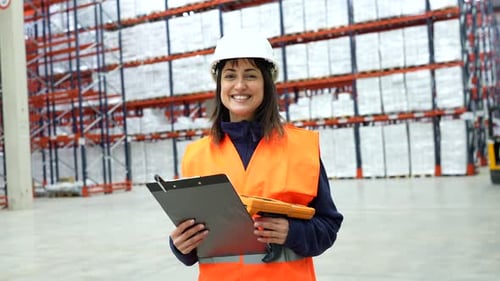 Female warehouse worker scanning and checking inventory