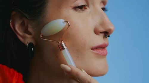 Young Adult Using Facial Roller for Skincare