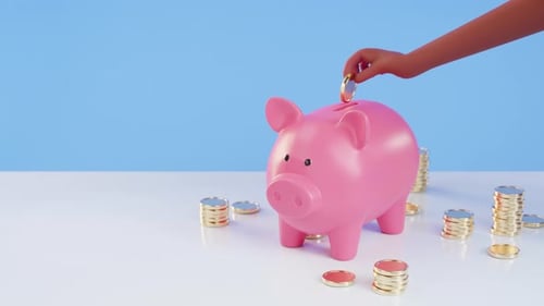 A piggy bank and stacks of coins. A hand placing a coin inside. concept of investment and saving