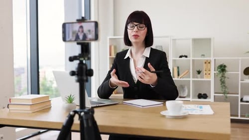 Woman Recording Business Blog in Modern Office Setting