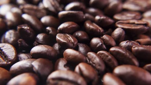 Close-up of the camera flying around roasted brown coffee beans