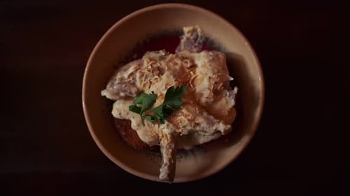 Close Up Plated Chicken Leg with Creamy Sauce