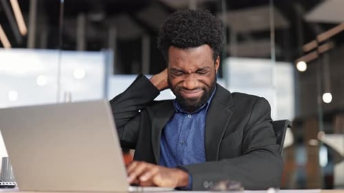 Tired Businessman Working Late in Office Suffering From Neck Pain