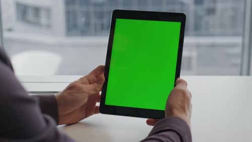 Unknown man holding tablet chromakey checking presentation at city view workplace