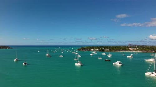 Perfect Summer Holiday Scenery with Many Luxury Boats Anchored in a Serene Turquoise Lagoon