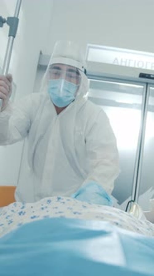 Healthcare Worker Dressed in Protective Gear Providing Care and Attention to Patient